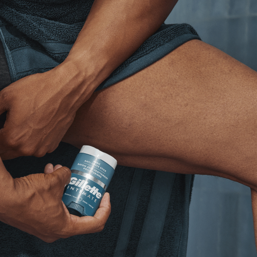 close-up of person applying anti-chafe stick underneath leg